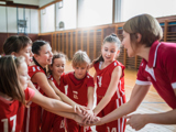 children playing basketball and coach
