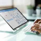 hands typing on a keyboard in a medical office